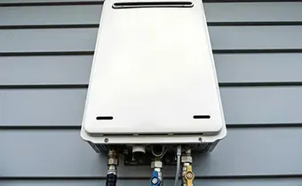 Tankless water heater installed on an exterior wall