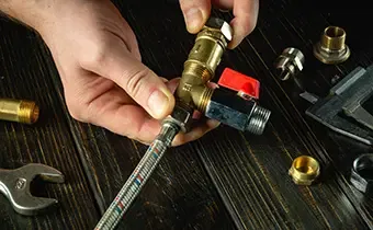 Technician hands assembling a brass backflow prevention valve
