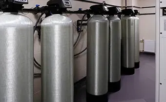 Commercial water filtration tanks in a clean utility room