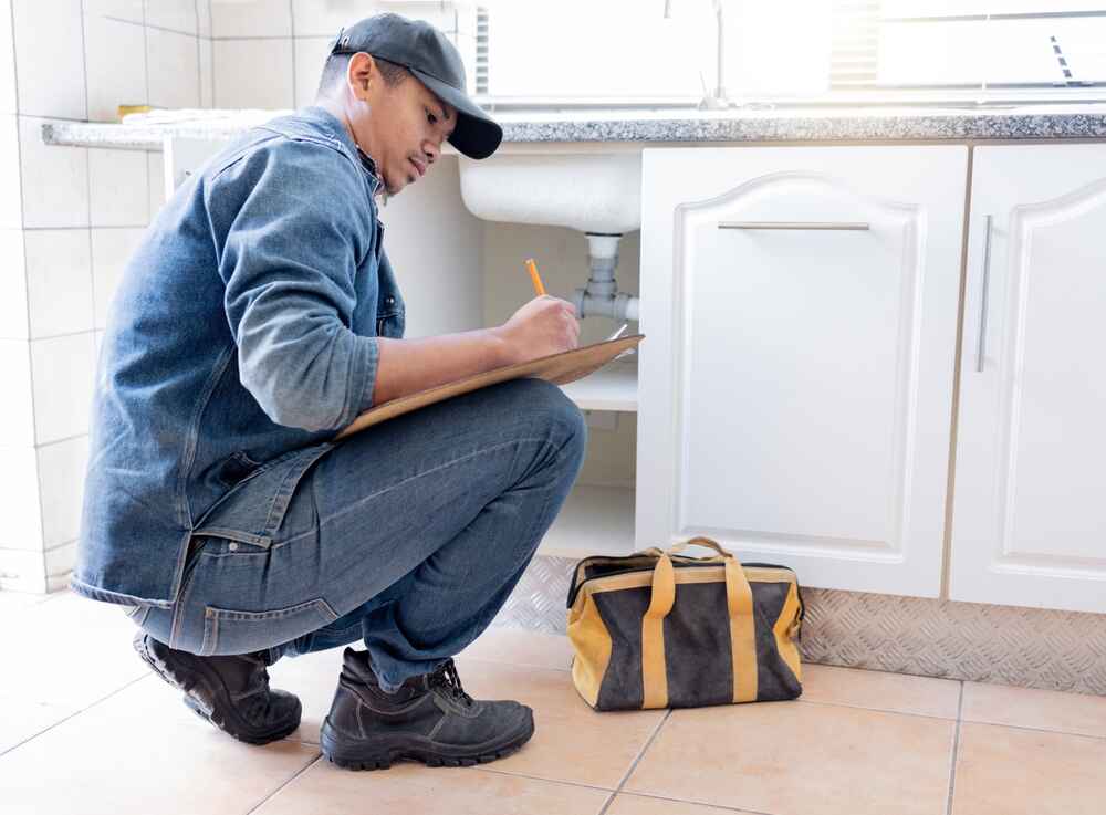 technician conducting a plumbing inspection