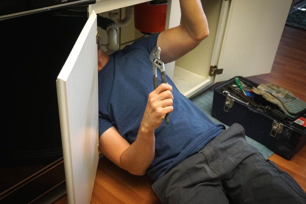 A plumber repairing a pipe