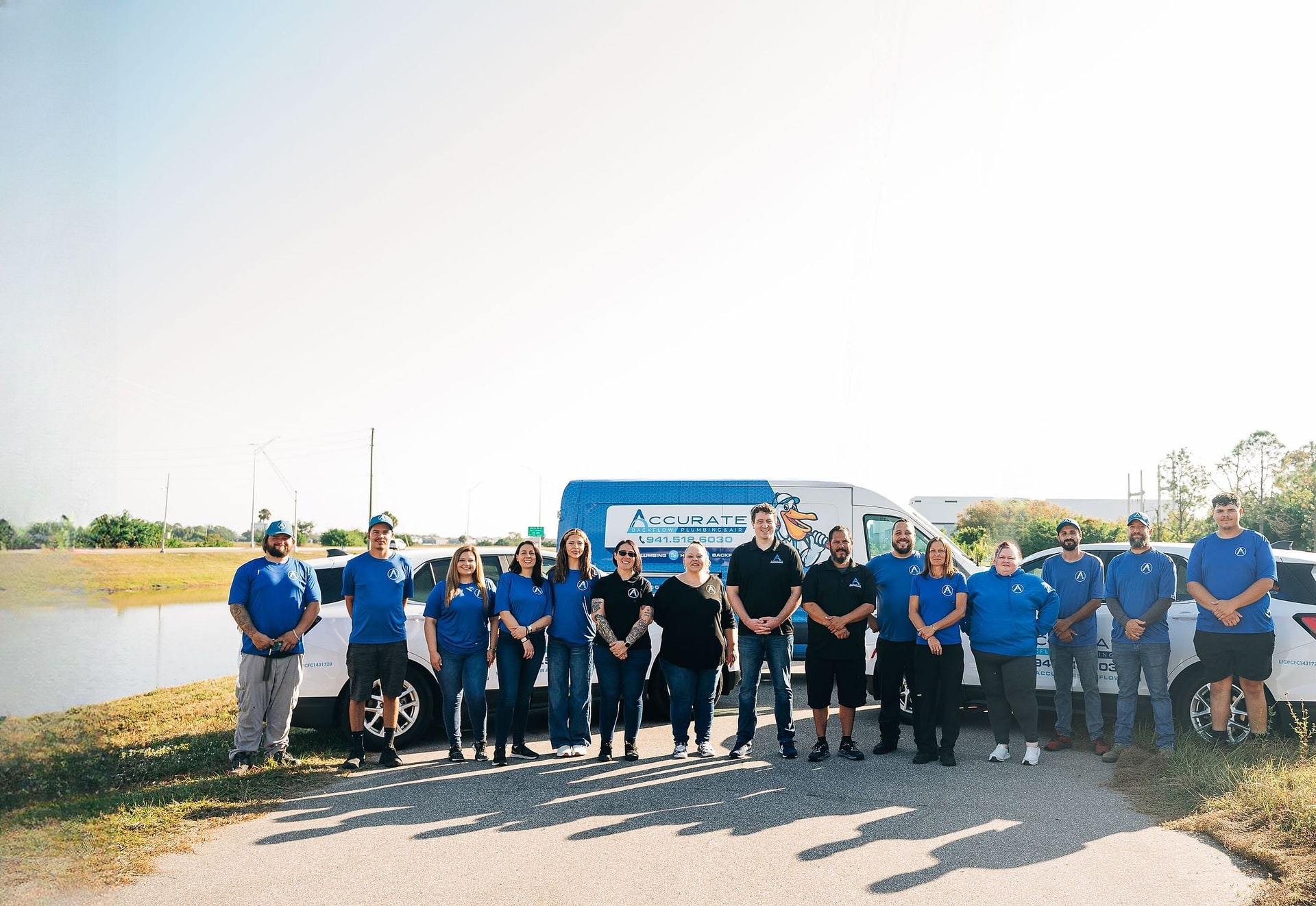 The Accurate Backflow & Plumbing team in front of the service fleet