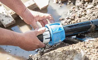 plumber repairing sewer pipe